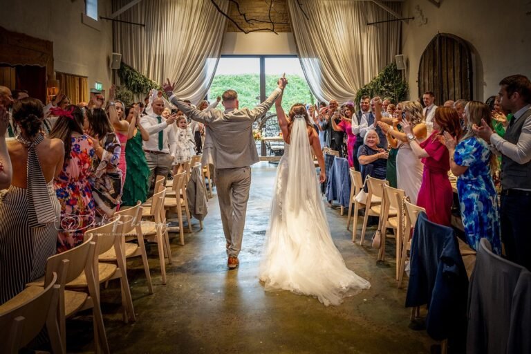 Bride and groom exit their ceremony, a perfectly captured moment from their UK wedding photography